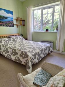 a bedroom with two beds and a couch at 2 White Horse Cottages in Washford