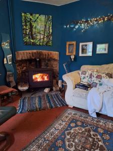 a living room with a couch and a fireplace at 2 White Horse Cottages in Washford