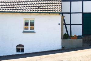 a white building with a window on the side of it at Bergische Ferienwohnung in Engelskirchen +11 photos