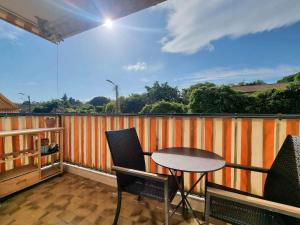 a balcony with a table and chairs on a balcony at Appartement entier cosy au calme in Le Cannet +22 photos