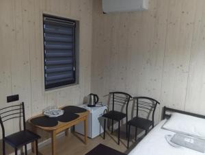 a room with a small table and chairs and a bed at Мотель "КАЛИНА" in Yavoriv