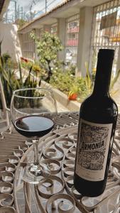 a bottle of wine and a glass on a table at Villa Garza Inn in Guayaquil