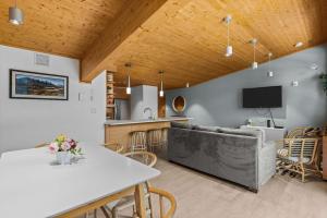 a kitchen and living room with a table and a couch at Alps #201- LEED Gold Certified & Dog Friendly in Canmore +45 photos