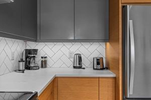 a kitchen counter with two coffee makers on it at Alps #201- LEED Gold Certified & Dog Friendly in Canmore