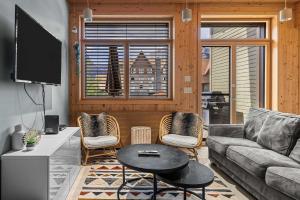 a living room with a couch and a table at Alps #201- LEED Gold Certified & Dog Friendly in Canmore