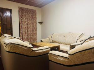 a living room with two chairs and a couch at Freedom City Anex in Dambulla