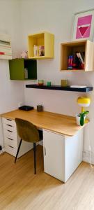 a desk in a room with a chair and a table at Studio centre Rennes in Rennes +1 photo