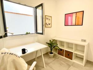 a white room with a desk and a window at Weybeach 7 - New, modern, stylish, fully equipped in La Santa