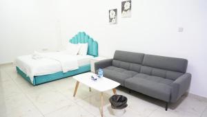 a living room with a couch and a bed at Golden Homes 2 in Dubai