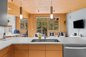a kitchen with a sink and a living room at Pyrenees #202 - LEED Gold Certified in Canmore