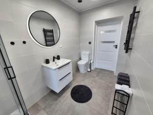 a white bathroom with a sink and a mirror at Villa Rico - Kalno in Kalno +25 photos