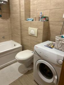 a bathroom with a washing machine and a toilet at Cozy corner Mostar in Mostar +27 photos