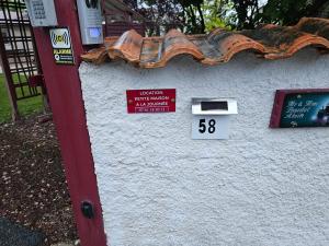 a sign on the side of a building with a mailbox at Petite maison in Vendat +1 photo