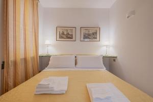 a bedroom with a bed with two towels on it at Elegant apartment inside the Roman Forum in Rome +19 photos