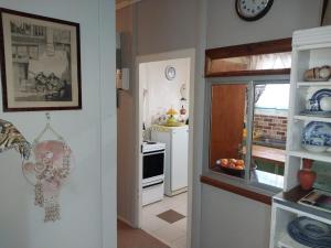 a room with a kitchen with a stove and a window at Vergenoeg't Country Estate in Hanover