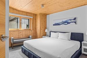 a bedroom with a large bed and a window at Dolomites #203 - LEED Gold Certified in Canmore