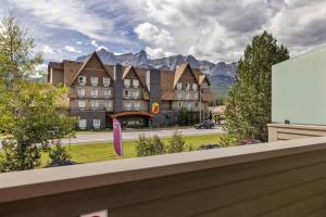 a view of a building with mountains in the background at Dolomites #203 - LEED Gold Certified in Canmore