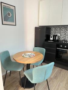 a kitchen with a table and two chairs and a table at Appartamento in centro by La Dolce Riva in Lugo +11 photos