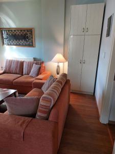 a living room with a couch and a table at Villa Exohi Rooftop in Exochí