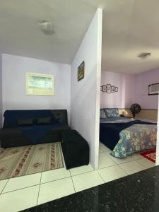 a living room with two beds and a couch at Flat Palladium in São Vicente +30 photos