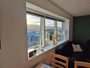 a living room with a window with two teddy bears at Cosy apartment in Norðskála in Norðskáli