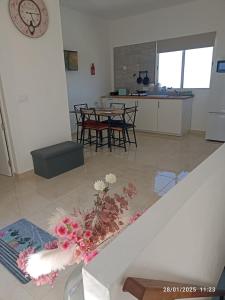 a living room and kitchen with a table and a vase of flowers at Vivienda LorenNani in El Paso