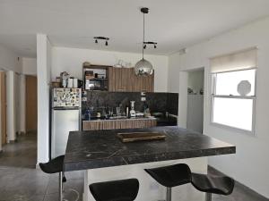a kitchen with a black counter top in a room at Country house, pool and gazebo 1600 m2, max 7 people in Santa Ana