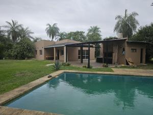 a house with a swimming pool in front of it at Country house, pool and gazebo 1600 m2, max 7 people in Santa Ana