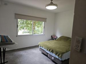 a bedroom with a bed and a window at Country house, pool and gazebo 1600 m2, max 7 people in Santa Ana +8 photos