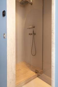 a shower with a glass door in a bathroom at Suite d'exception Marais in Paris