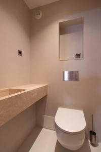 a bathroom with a white toilet and a mirror at Suite d'exception Marais in Paris