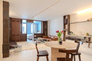 a living room with a table and a couch at Suite d'exception Marais in Paris