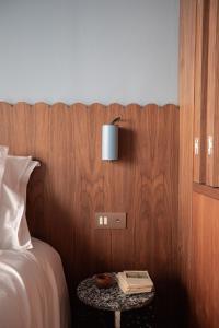 a bedroom with a bed and a table with a lamp at Suite d'exception Marais in Paris