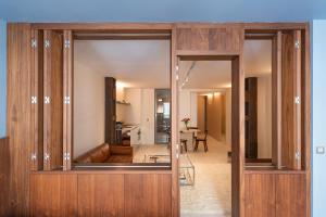 a room with wooden doors and a living room at Suite d'exception Marais in Paris