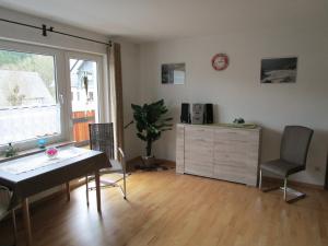 sala de estar con mesa, sillas y ventana en Apartment Albers en Schmallenberg
