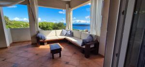 a living room with a couch and a large window at Apartman GriSo in Rukavac