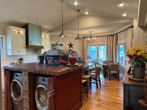 a kitchen with a washer and dryer on a counter at Welcome Valley Farm in Benton