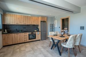 a kitchen with a table and chairs in a room at SeaZen Private House in Trapezaki