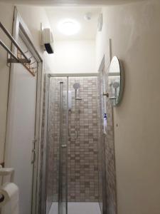 a bathroom with a shower with a glass door at Double Room in Winton in Bournemouth