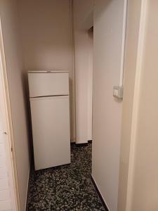 an empty hallway with a white refrigerator in a room at La casa di nonna Angela in Sassello
