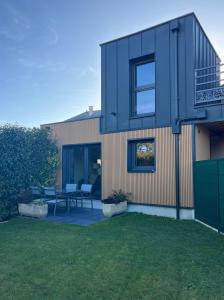 a house with two chairs and a patio at La Maison d'à Coté in Saint-Jean-le-Blanc