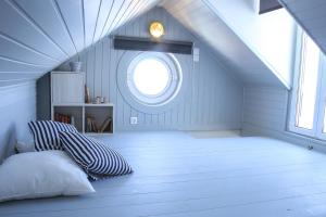 a attic room with a bed and a window at Camara Homes in Andros