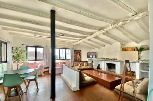 a living room with a table and a fireplace at Casa Virgen de la Vega in Añover de Tajo