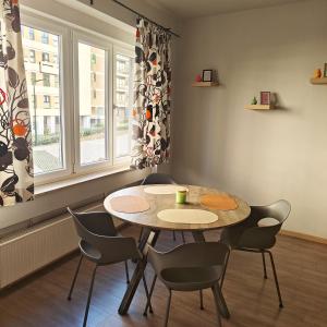 Una mesa y sillas en una habitación con ventana. en Splendid 2 bedroom apartment in Etterbeek, en Bruselas