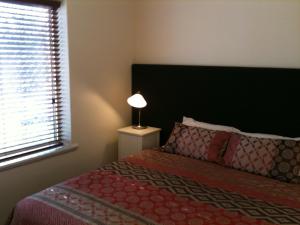 A bed or beds in a room at Adelaide - Semaphore Beach Front