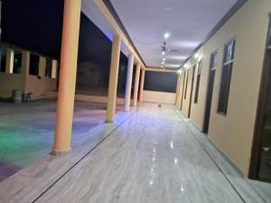 an empty hallway of an office building at night at Jai maa meldy restaurant in Gudali +2 photos