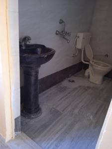 a bathroom with a sink and a toilet at Jai maa meldy restaurant in Gudali