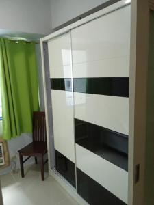 a glass cabinet with black and white stripes at Sea Residences david in Manila