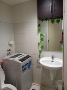 a small bathroom with a sink and a toilet at Sea Residences david in Manila