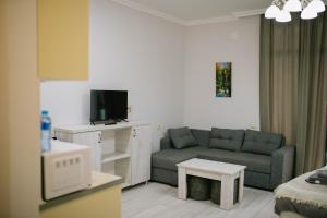 un soggiorno con un divano e una TV di Lumari Apartment a Kakhaberi